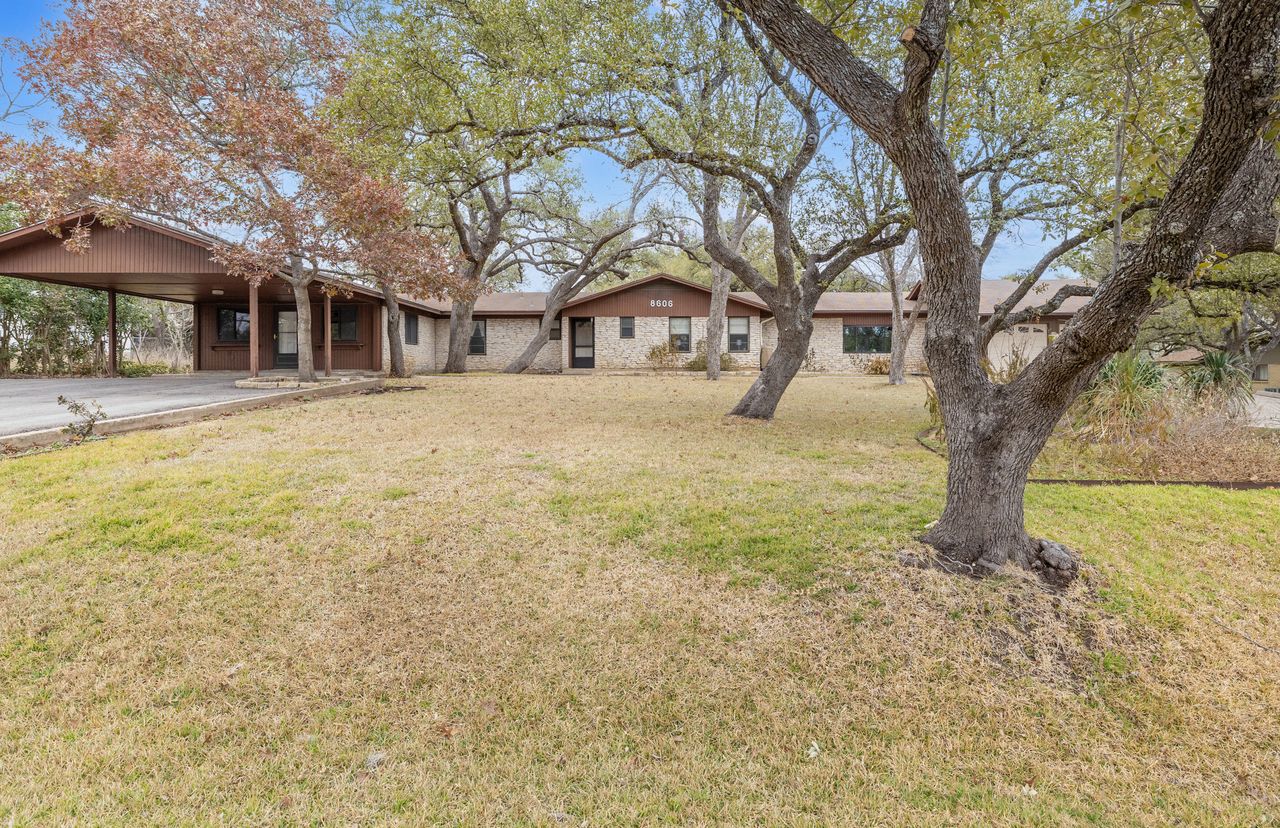 8606 Thunderbird Road, Unit A & B Austin, TX 78736 - Photo 32 of 33 View of green lawn featuring an attached carport