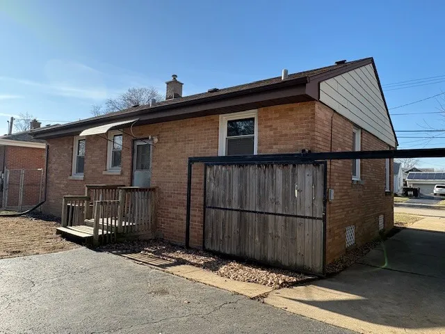 a view of a house with wooden fence