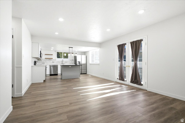 1676 East 11245 South Sandy, UT 84092 - Photo 7 of 34 Open-concept living space with wood-finish flooring and recessed lighting