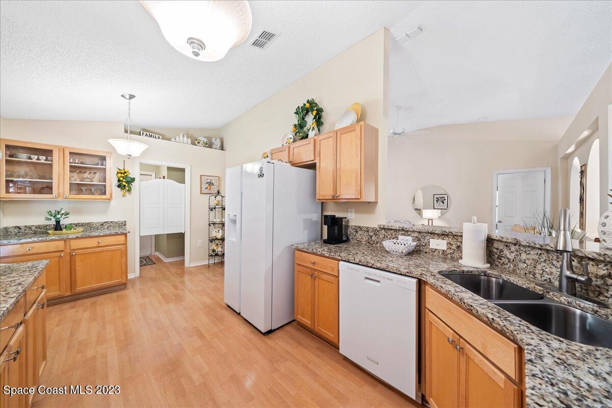 2190 Spring Creek Circle Palm Bay, FL 32905 - Photo 16 of 73 a kitchen with a sink stove and refrigerator
