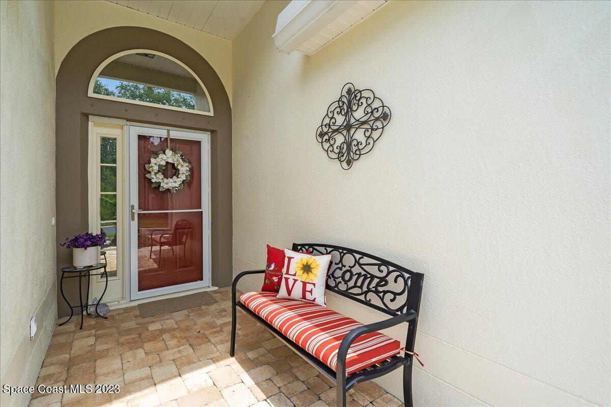 2190 Spring Creek Circle Palm Bay, FL 32905 - Photo 2 of 73 a view of staircase with a rug and a potted plant