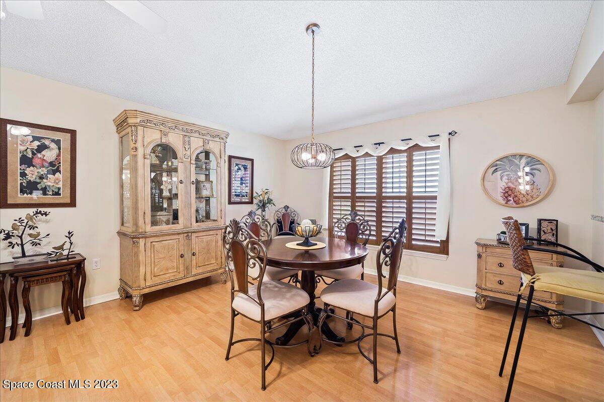 2190 Spring Creek Circle Palm Bay, FL 32905 - Photo 21 of 73 a view of a dining room with furniture and chandelier