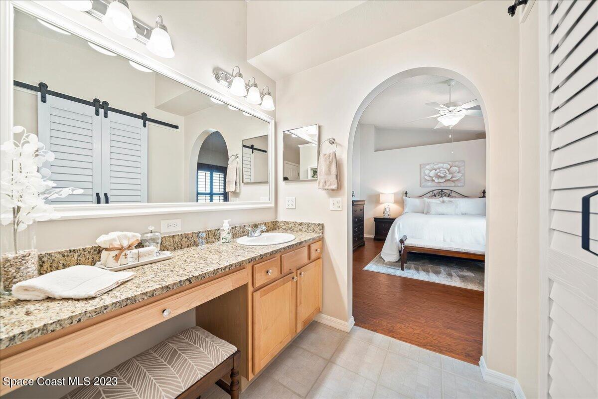 2190 Spring Creek Circle Palm Bay, FL 32905 - Photo 29 of 73 a en suite bathroom with a granite countertop double vanity sink and a mirror