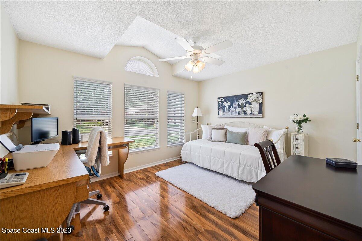 2190 Spring Creek Circle Palm Bay, FL 32905 - Photo 32 of 73 a bedroom with a bed and a large window