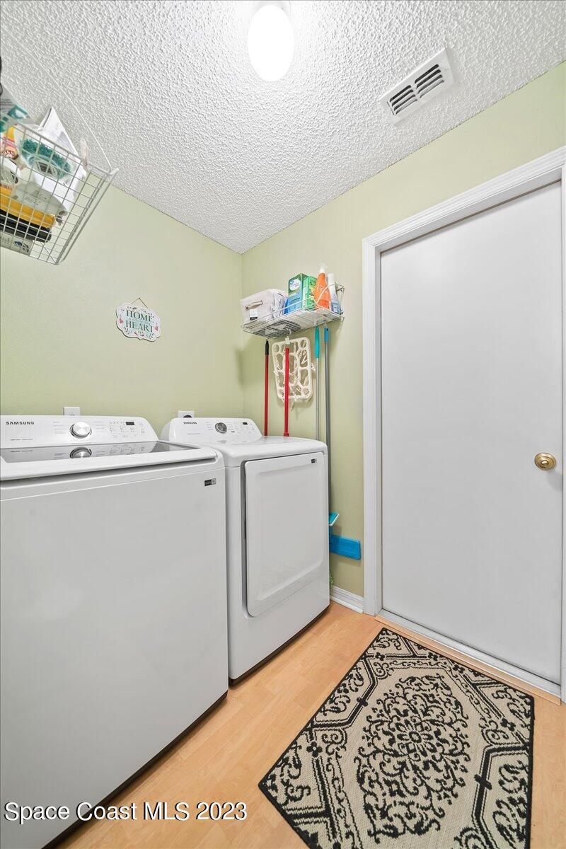 2190 Spring Creek Circle Palm Bay, FL 32905 - Photo 36 of 73 a utility room with dryer and washer