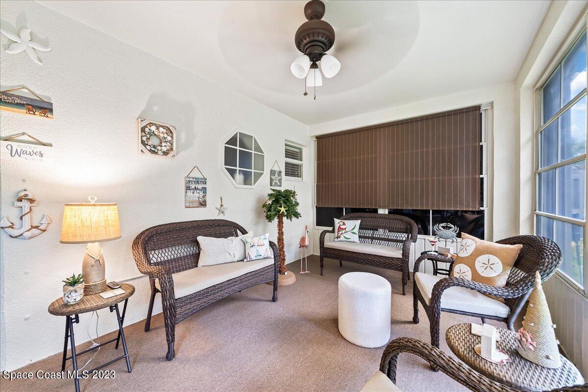 2190 Spring Creek Circle Palm Bay, FL 32905 - Photo 37 of 73 a living room with furniture and a chandelier