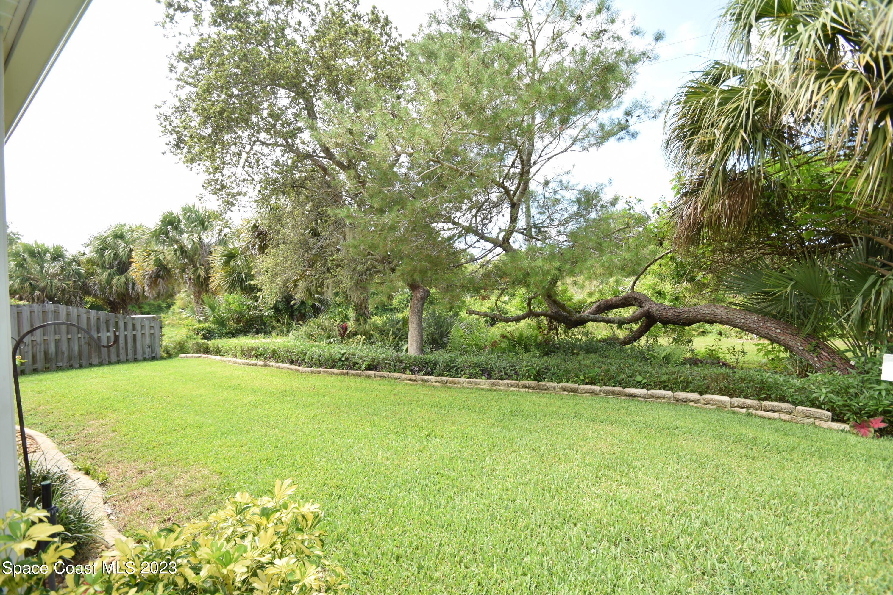 2190 Spring Creek Circle Palm Bay, FL 32905 - Photo 42 of 73 a view of a field with large trees