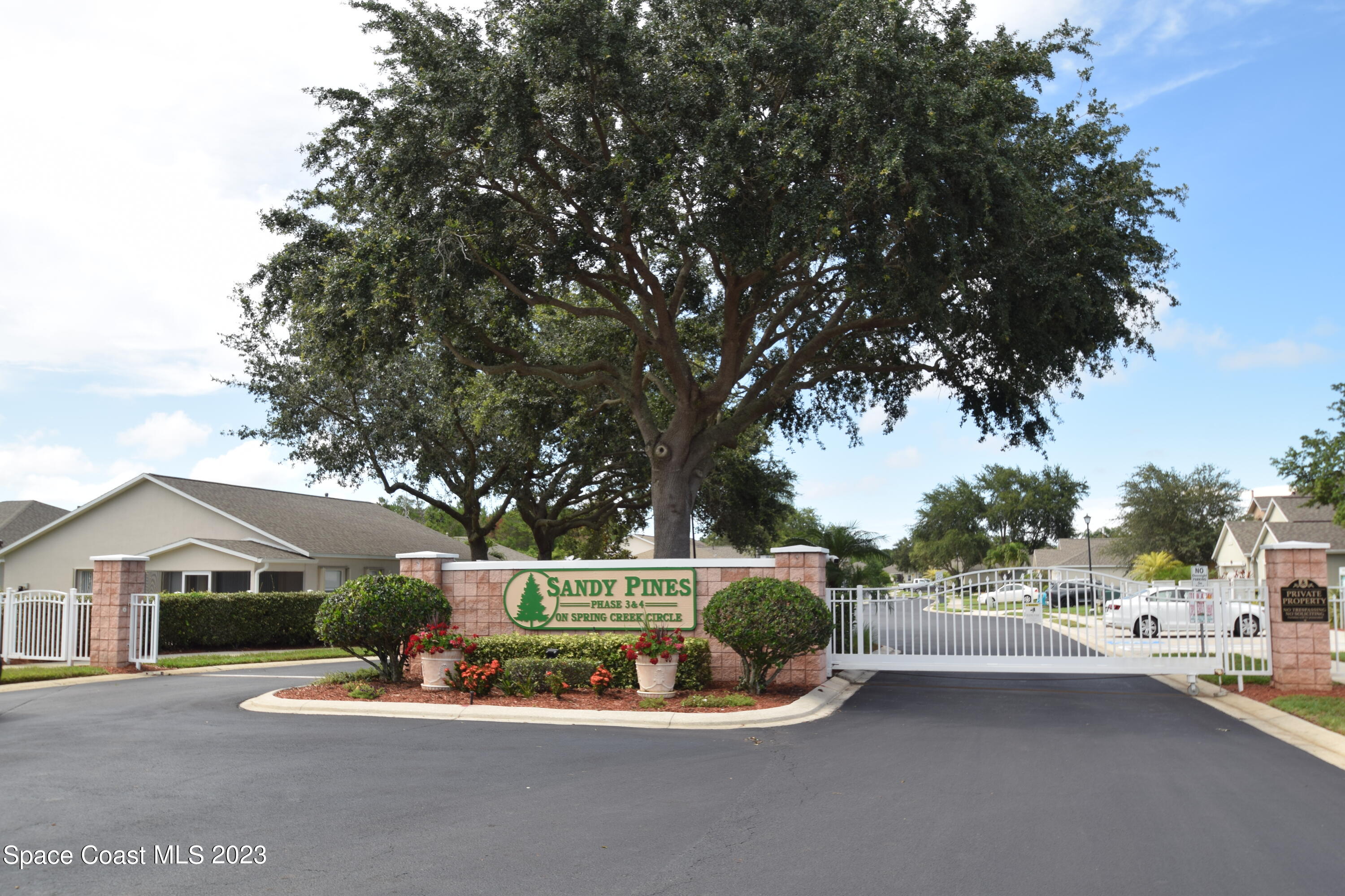 2190 Spring Creek Circle Palm Bay, FL 32905 - Photo 46 of 73 a white house with a tree in the background