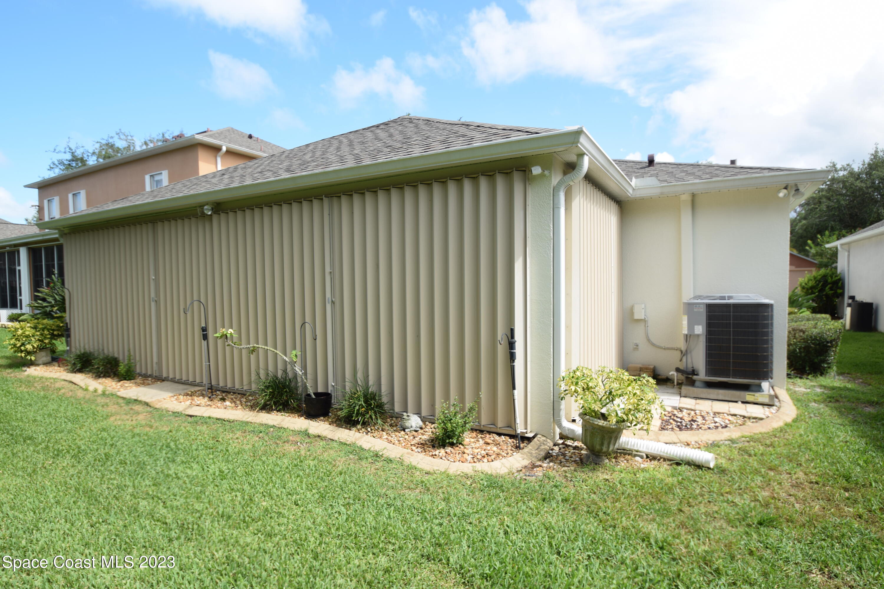 2190 Spring Creek Circle Palm Bay, FL 32905 - Photo 48 of 73 a backyard of a house with table and chairs