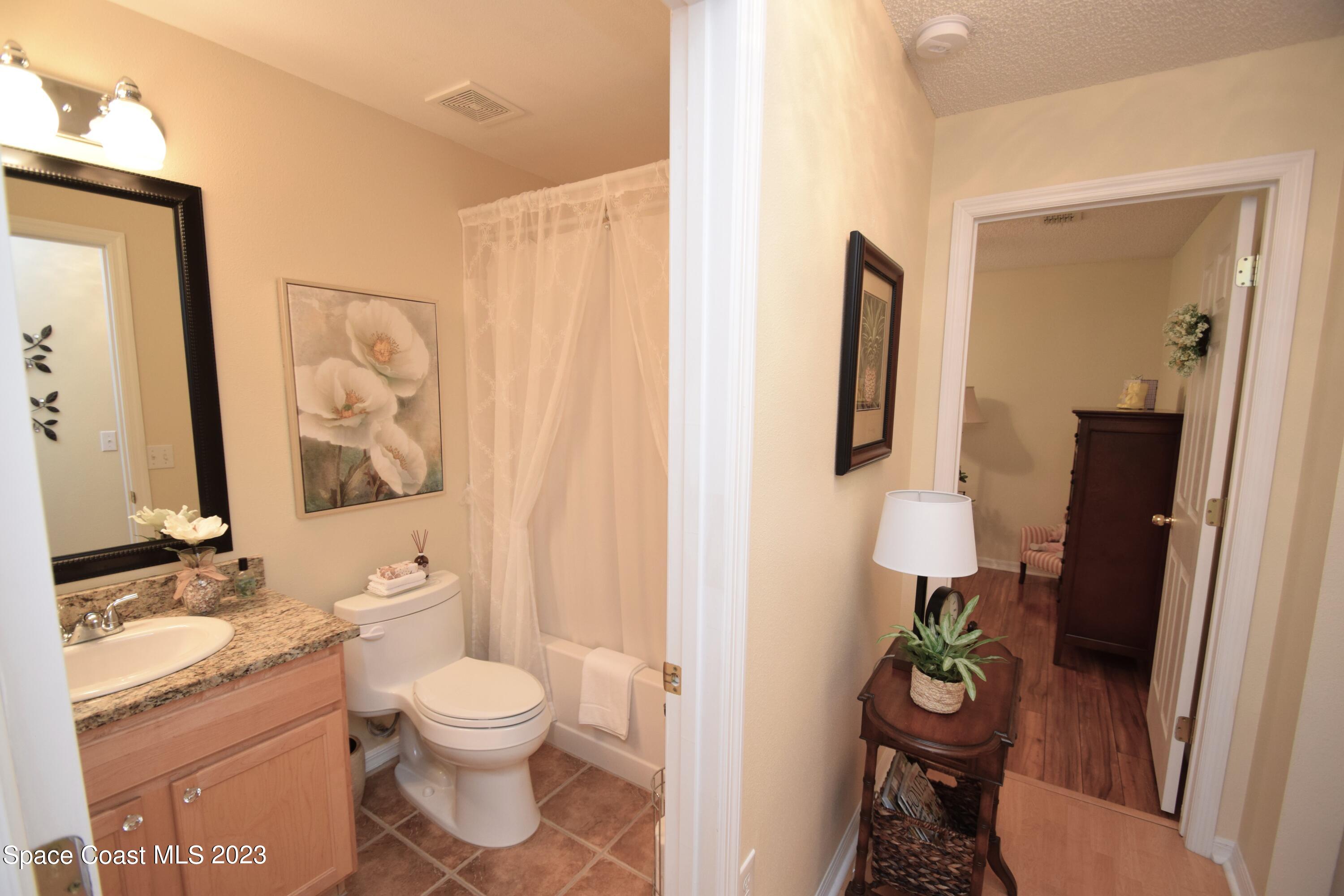 2190 Spring Creek Circle Palm Bay, FL 32905 - Photo 56 of 73 a bathroom with a toilet sink and mirror