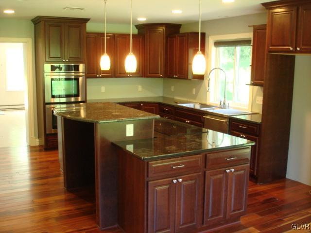 124 Longley Road Nazareth, PA 18064 - Photo 4 of 20 a kitchen with a sink and wooden cabinets