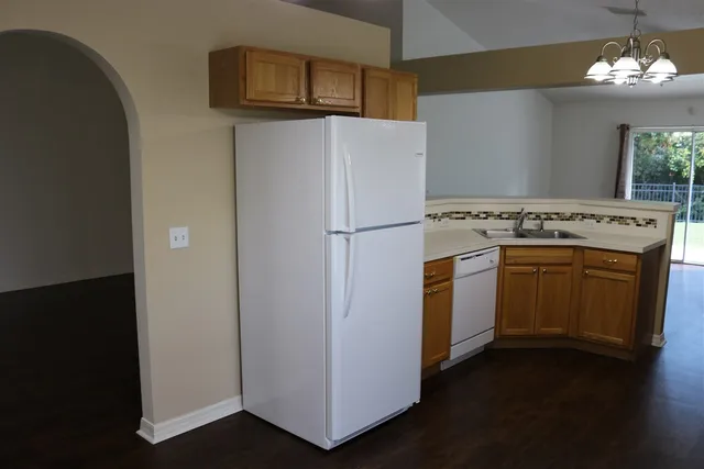 a kitchen with a stove top oven and a refrigerator