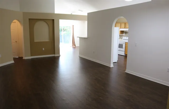 a view of a room with wooden floor and a window