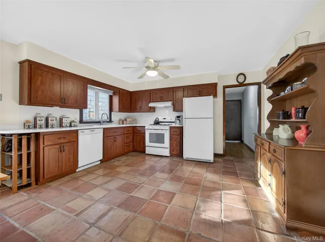 a kitchen with a cabinets a sink stainless steel appliances and cabinets