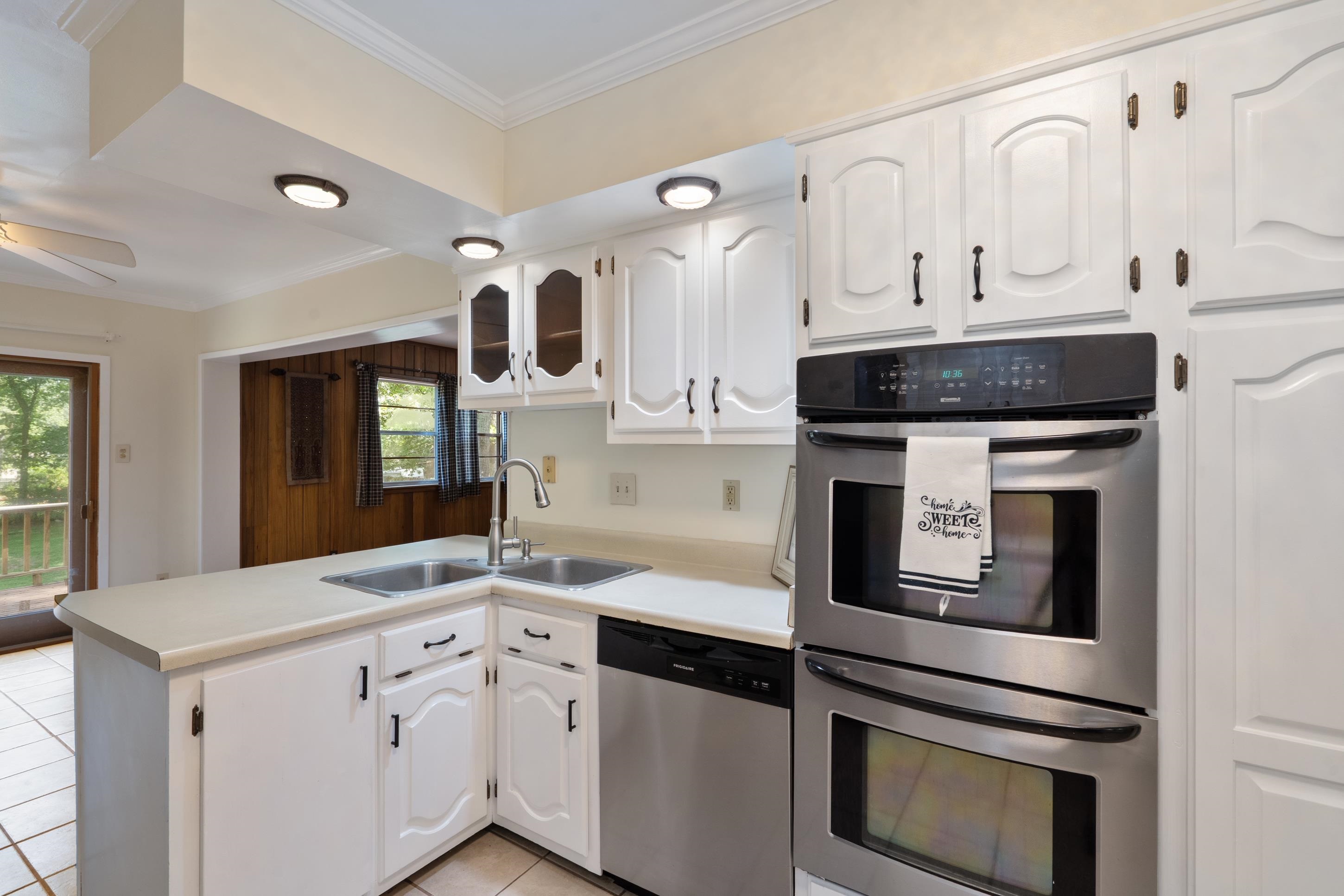 6164 Elmore Road Bartlett, TN 38134 - Photo 11 of 25 a kitchen with granite countertop white cabinets and white appliances