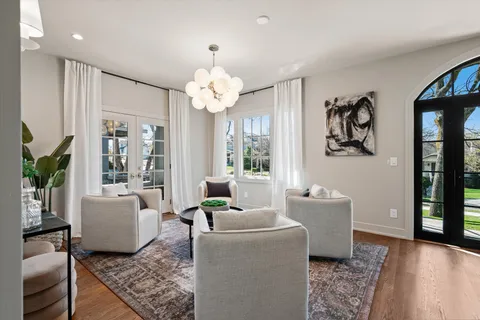 a bedroom with a large bed and a chandelier