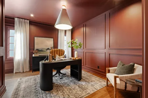 a view of a dining room with furniture and a large window