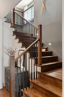 a living room with fireplace furniture and a large window