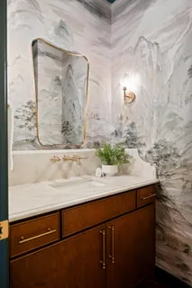 a kitchen with stainless steel appliances granite countertop a stove a refrigerator a kitchen island a table and chairs