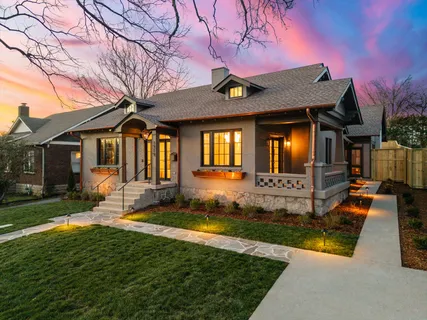 a view of a house with backyard porch and sitting area