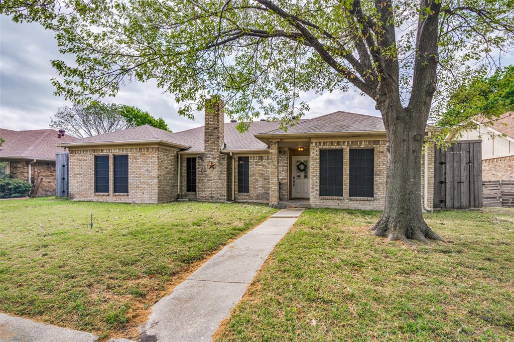 This charming single-story brick home with mature shade tree, inviting walkway, and great curb appeal.