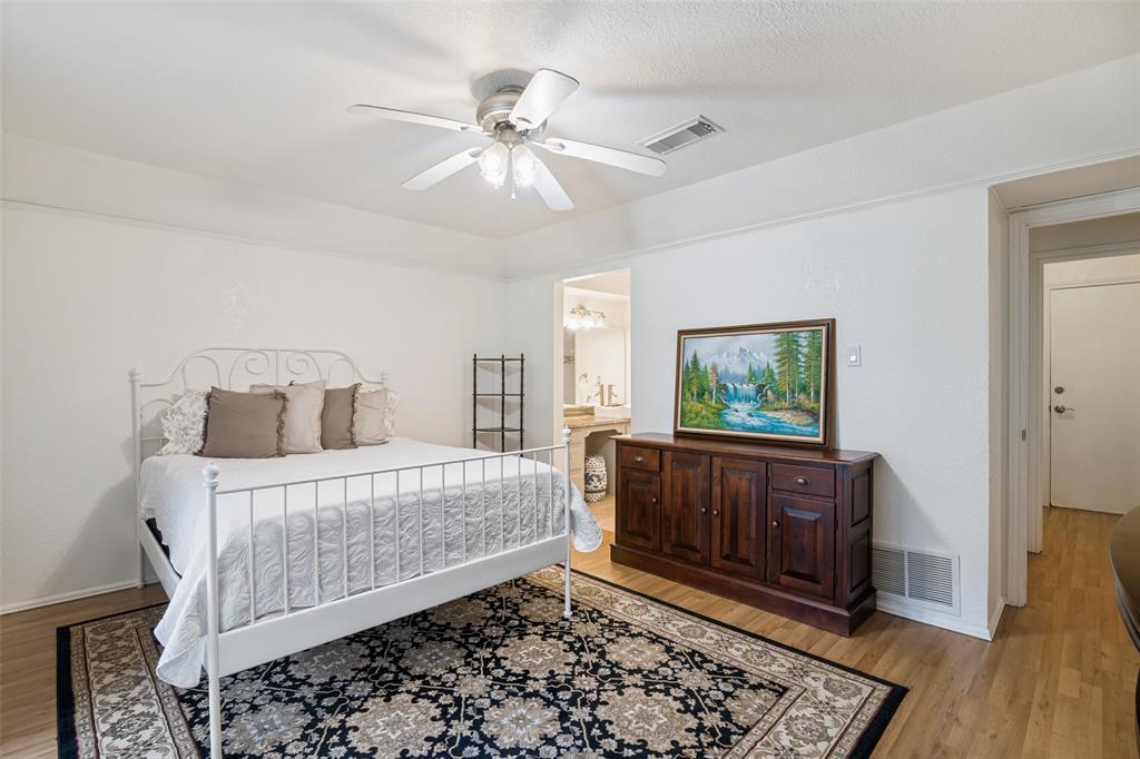 7706 Swiss Way Rowlett, TX 75089 - Photo 12 of 21 Generous sized bedroom featuring convenient access to the ensuite bath.