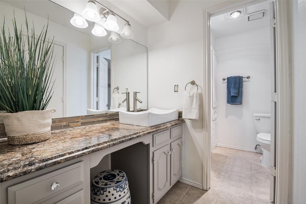 7706 Swiss Way Rowlett, TX 75089 - Photo 13 of 21 Updated bathroom featuring granite countertop, vessel sink, and stylish backsplash with plenty of counter space.