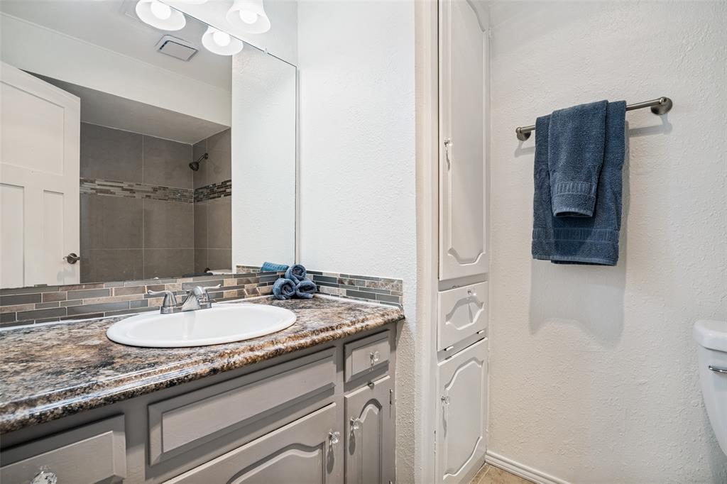 7706 Swiss Way Rowlett, TX 75089 - Photo 14 of 21 Full bath with granite vanity updated fixtures, and convenient access to shower area.
