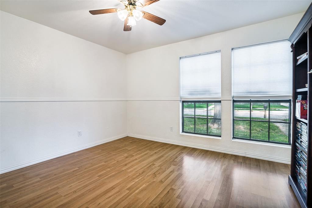 7706 Swiss Way Rowlett, TX 75089 - Photo 16 of 21 Spacious secondary bedroom with ceiling fan and lots of natural light.