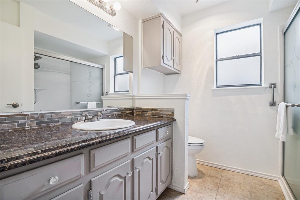 7706 Swiss Way Rowlett, TX 75089 - Photo 18 of 21 Full bath with vanity, updated finishes, and walk-in shower.