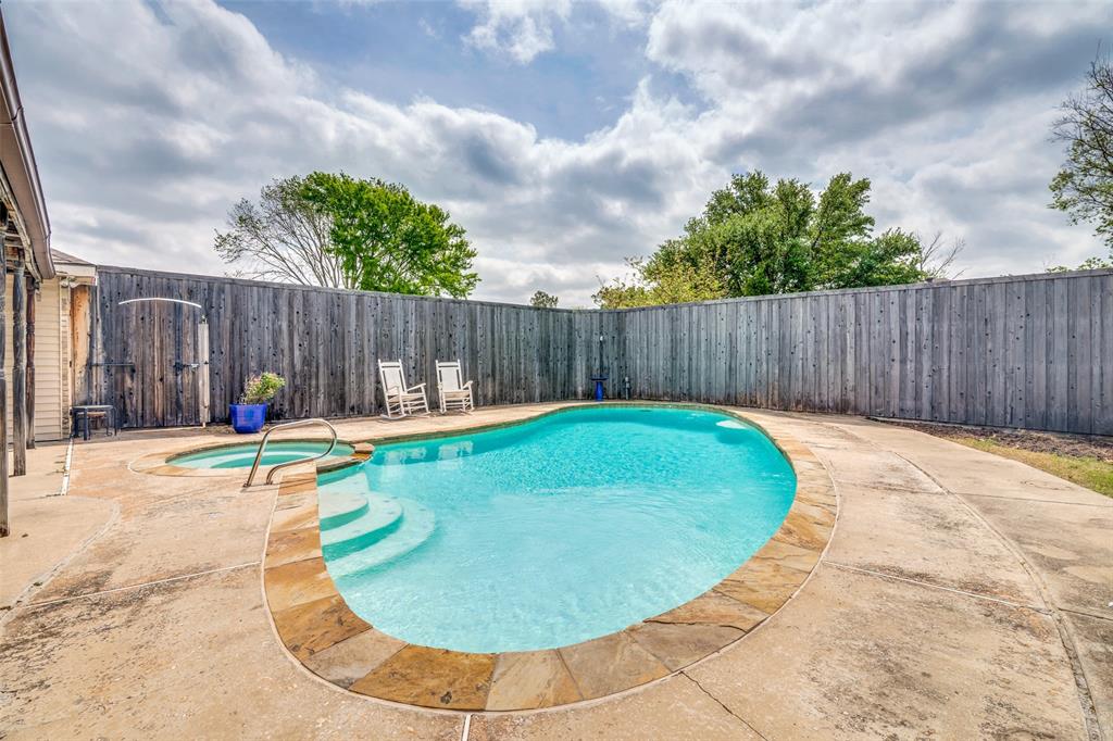 7706 Swiss Way Rowlett, TX 75089 - Photo 19 of 21 Sparkling pool with attached whirlpool and spacious patio perfect for relaxing or entertaining.