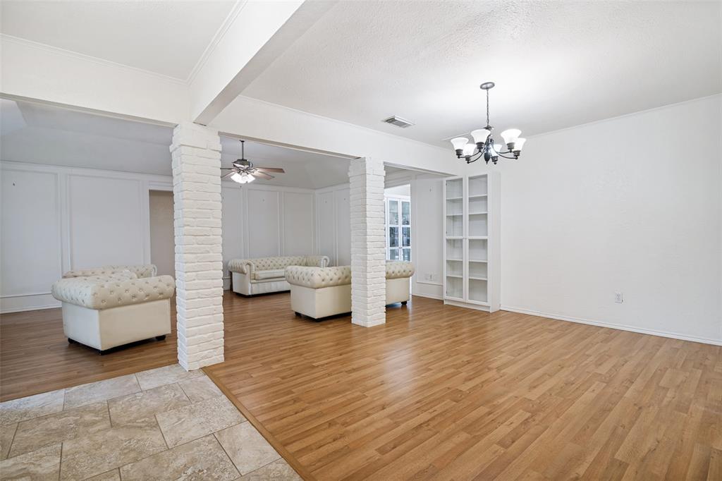 7706 Swiss Way Rowlett, TX 75089 - Photo 3 of 21 Bright and open living room with decorative columns and seam flow perfect for everyday living and entertaining.