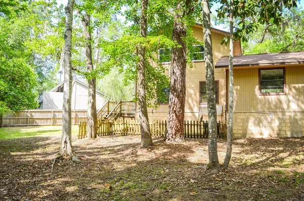 a backyard of a house with a tree