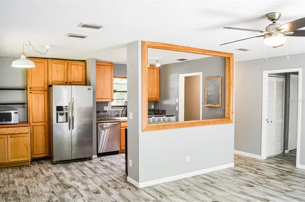 a kitchen with stainless steel appliances granite countertop a refrigerator and a stove