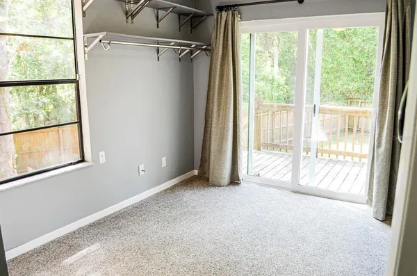 a view of empty room with floor to ceiling window