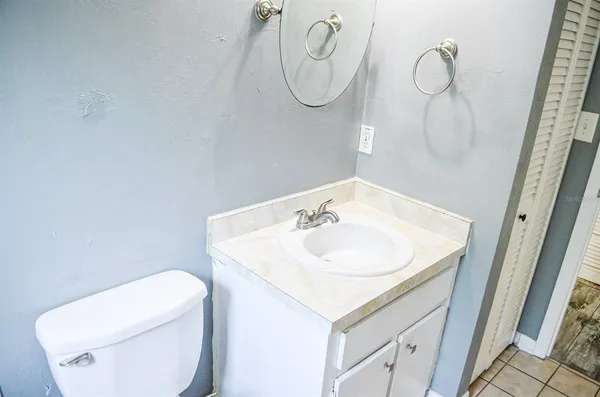a bathroom with a sink a toilet and a mirror