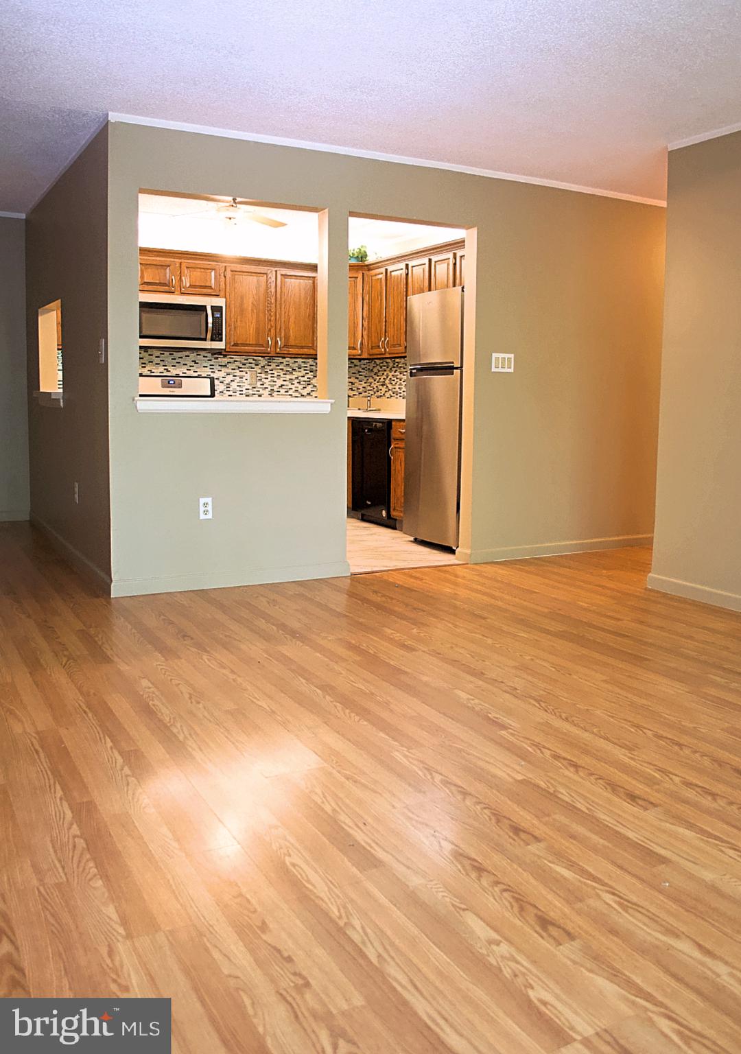 84 Willow Court Hamilton, NJ 08619 - Photo 3 of 18 an empty room with wooden floor and windows