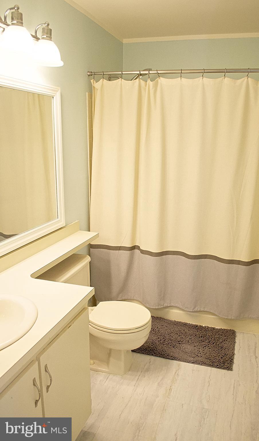 84 Willow Court Hamilton, NJ 08619 - Photo 10 of 18 a bathroom with a toilet and a shower curtain