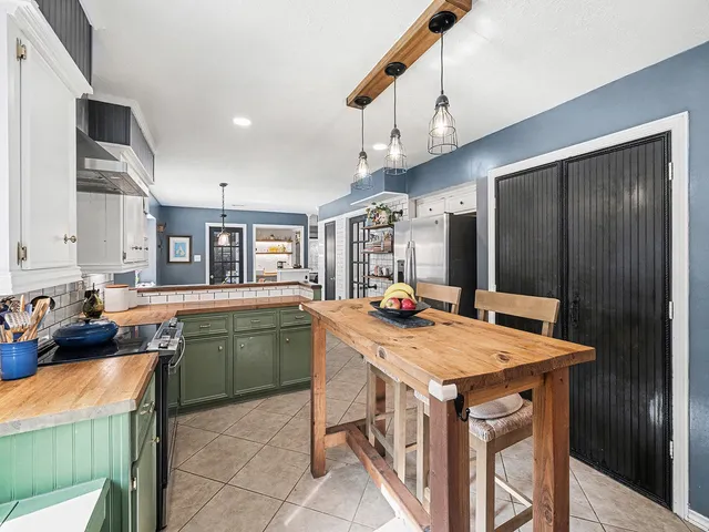 a kitchen that has a cabinets a sink and a stove in it