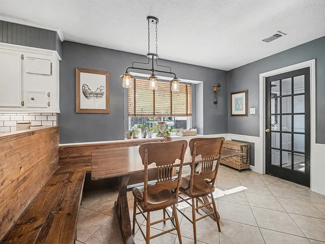 a dining room with furniture and window