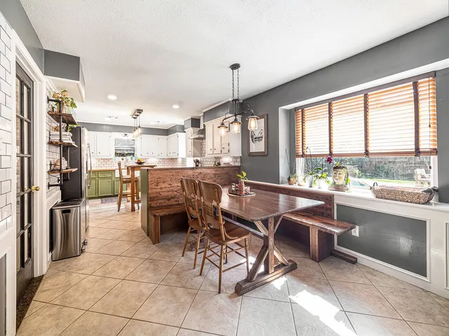 a open kitchen with stainless steel appliances granite countertop a stove and a refrigerator