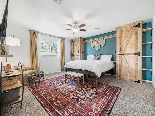 a bedroom with furniture and a rug