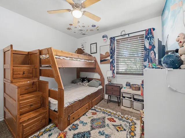 a bedroom with a bed and a chandelier