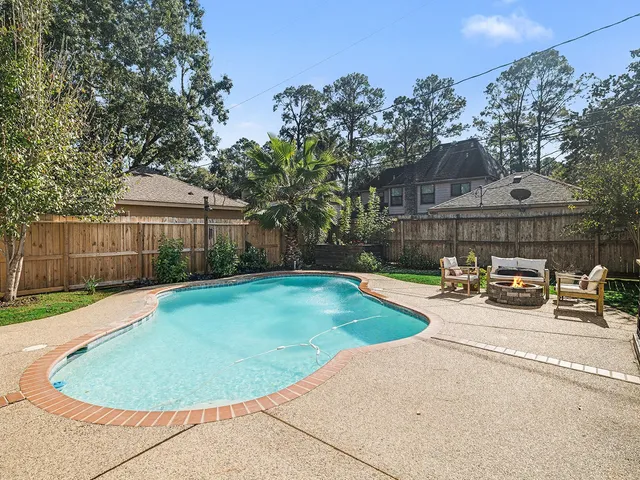 a view of a swimming pool in the backyard of house