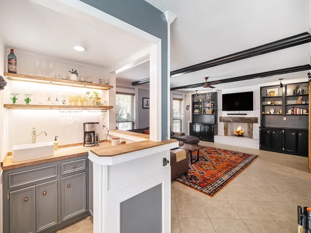 a very nice looking living room with a large window and flat screen tv