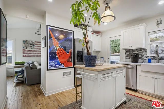 a view of kitchen with stainless steel appliances granite countertop a stove a sink and a refrigerator