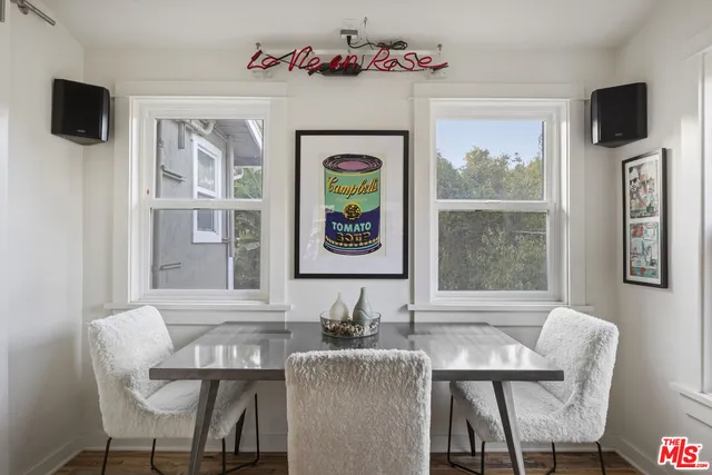 a view of a dining room with furniture window and wooden floor