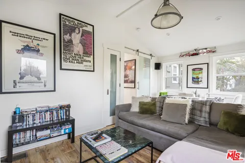 a living room with furniture a rug and a window