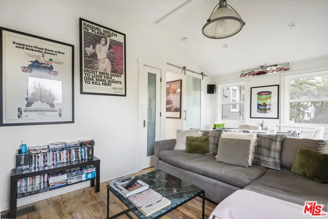 a living room with furniture a rug and a window