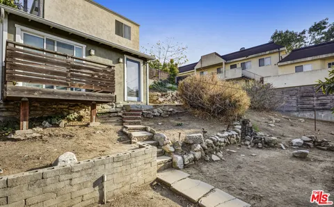 a living room with furniture and a book shelf